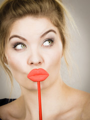 Canvas Print - Funny woman holding big red lips on stick