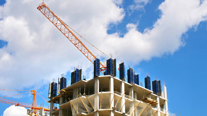 Skyscraper construction. Cranes and building under construction.