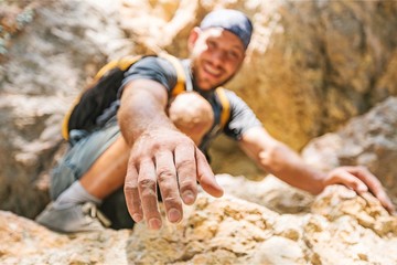 Adventurers helping each other to climb