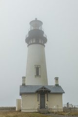 Wall Mural - Vertical image of Yaquina Head Lighthouse in the fog