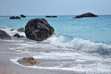 Wall Mural - waves hit the rock on the beach