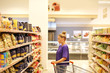 © lado2016 - Woman choosing a dairy products at supermarket