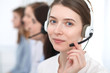 © rogerphoto - Call center. Beautiful cheerful smiling operator consulting clients with headset. Business concept of customer service
