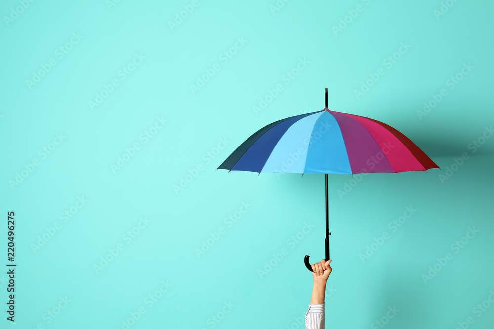 Woman holding beautiful umbrella on color background with space for design - obrazy, fototapety, plakaty 