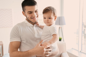 Canvas Print - Young dad with his little son at home