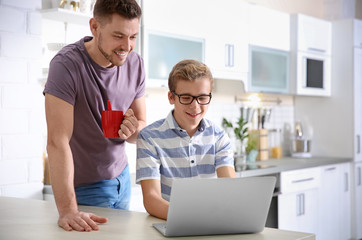 Canvas Print - Teenager with father doing homework at home