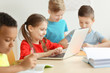 © Africa Studio - Cute children doing homework in classroom at school