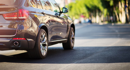 Canvas Print - car on the road on sunny spring evening in city