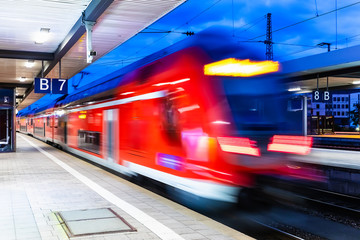 Wall Mural - High speed train at railway station platform at night