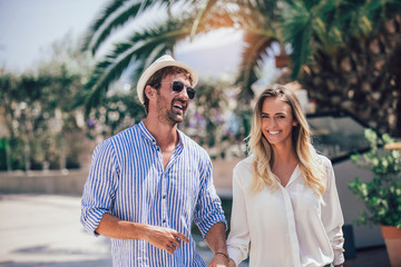 Beautiful couple taking a walk in city park