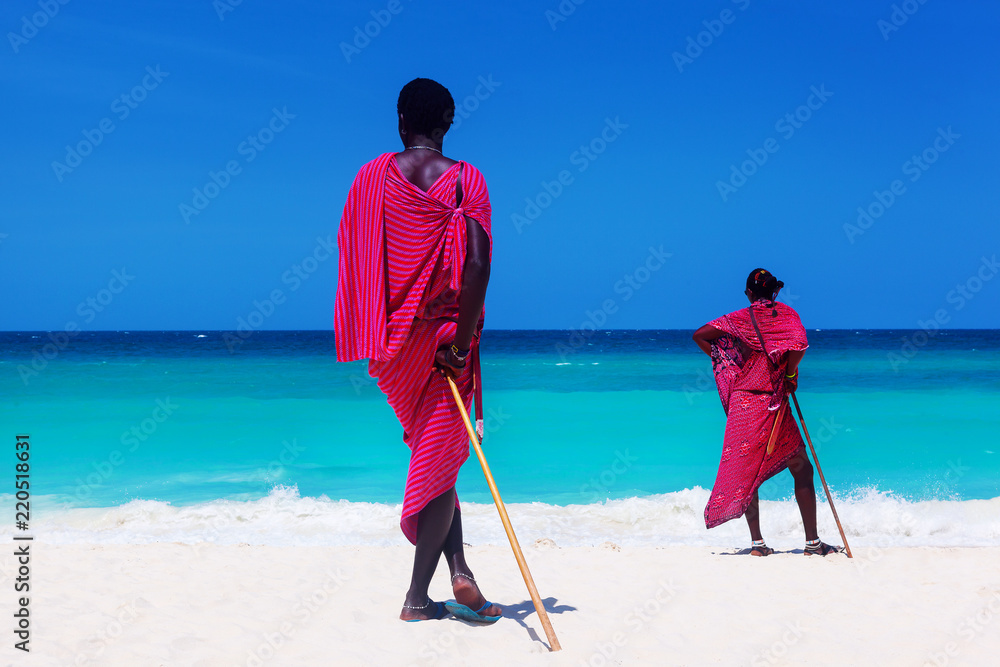 Two maasai warriors looking on ocean. - obrazy, fototapety, plakaty 