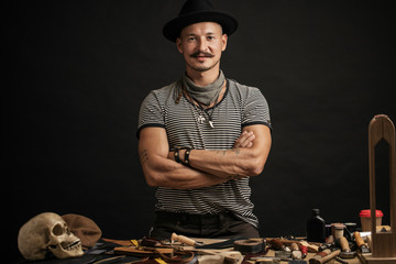 Wall Mural - Leather craftmans at his workshop. Pieces of leather and scobbler working tools on table. Small Business, Cobblering, Leather Workcraft