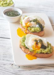 Wall Mural - Sandwiches with guacamole and poached eggs