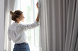 © New Africa - Young happy woman near window at home. Lazy morning
