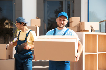 Wall Mural - Male mover with box outdoors on sunny day