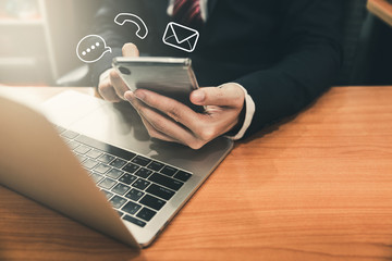 Business man using smart phone and laptop