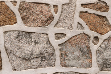 Fragment of a stone wall with a figured masonry