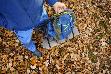 Men with backpack in forest.