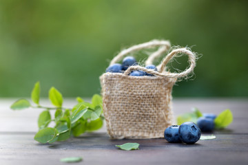 Wall Mural - Fresh ripe sweep tasty blueberries outdoors on wood