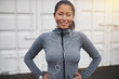 © Flamingo Images - Smiling young Asian woman standing outdoors ready for a run