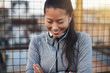 © Flamingo Images - Smiling Asian woman in sportswear standing outside before a run