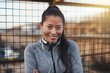 © Flamingo Images - Smiling young Asian woman listening to music before exercising o