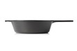 Empty, clean black cast iron pan or dutch oven side view over white