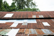 View of old style zinc roof with rust and lichen with