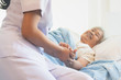 © Pormezz - asian female home nursing holding hand of older lady on the bed and encouraging patient
