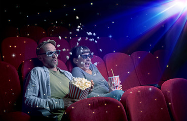 Wall Mural - Lovely couple watching 3D movie with little sparkling stars around