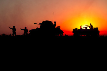 War Concept. Military silhouettes fighting scene. World War German Tanks and soldiers silhouettes at sunset. Attack scene. Armored vehicles.