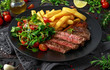 © grinchh - Grilled sirloin steak with potato fries and vegetables, tomato salad in a black plate. rustic table