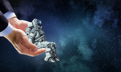 Wall Mural - spaceman on finger. mixed media