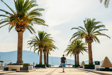 Man Walking By Pier In Summer Day