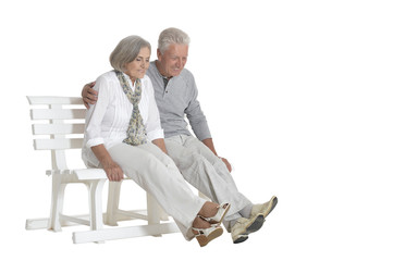 portrait of  senior couple sitting on bench