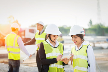 Wall Mural - Civil Engineer at construction site and worker checking plan on construction site