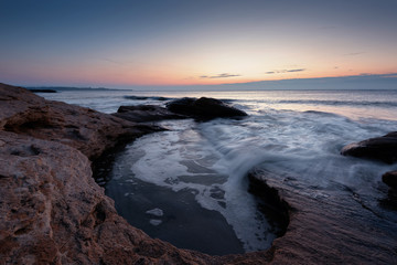 Wall Mural - Seascape during sunrise. Beautiful natural seascape, blue hour. Sea sunrise at the Black Sea coast. Magnificent sunrise with clouds and fire sun in the middle of December.Ravda, Bulgaria