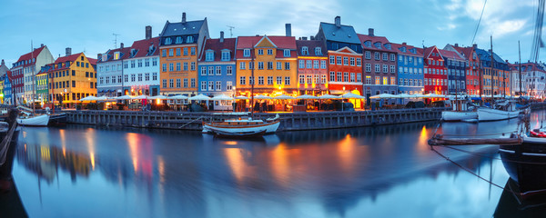 Wall Mural - Panorama of north side of Nyhavn with colorful facades of old houses and old ships in the Old Town of Copenhagen, capital of Denmark.