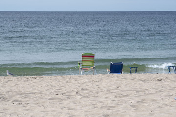 sand chairs by the water