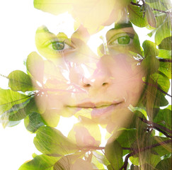 Double exposure close up portrait of a naturally beautiful fair-skinned woman and bright green tropical leaves