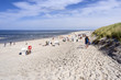 Germany, North Sea, Spiekeroog: Panorama view with people, beach chairs, green dunes on white beach of famous German touristic island - concept holiday luxury nature environment. August 17, 2018