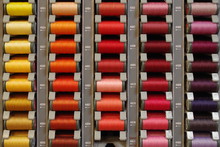 Colored Cotton Bobbins In A Vintage Shop With All Textile Items Available. 