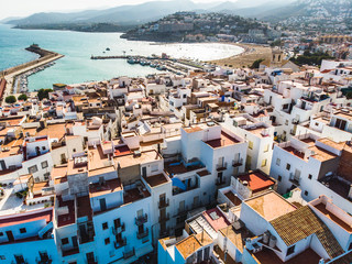 Wall Mural - white houses and roofs of the Spanish city of Peniscola. view from drone aerial photo. province of Castellon, Valencian Community, Spain.