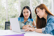 © Mymemo - Business meeting. Two young coworker woman team making business discussion in modern office. Teamwork people concept. Casual account manager crew working new startup project on laptop. Presentation