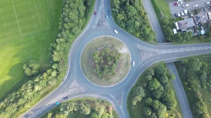Poster - Top down aerial view of cars using a traffic roundabout in an urban UK town