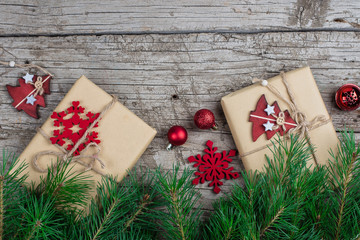 Wall Mural - Christmas background with red decorations, fir tree branch and gift boxes on wooden board. Flat Lay, Top view, Copy Space