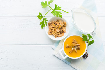 Overhead view of pumpkin cream soup with dry bread