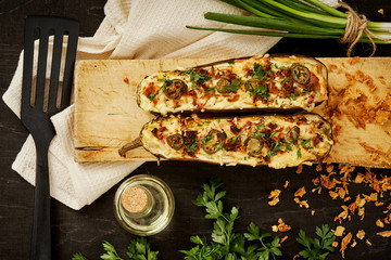 Wall Mural - delicious casserole of aubergine cheese and jalapeno peppers on a black table