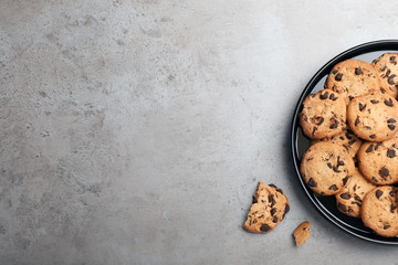 Wall Mural - Plate with chocolate cookies and space for text on gray background, top view