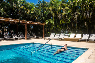 Woman in a luxury swimming pool